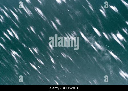 The image is of a body of water with a lot of white snow on it Stock Photo