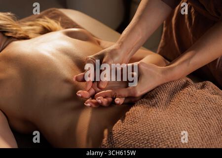 Detailed view of female therapist giving back massage in tranquil spa for relaxation, health, and stress relief Stock Photo
