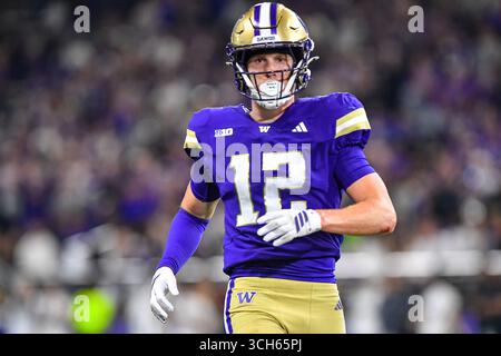Washington safety Alex McLaughlin (12) tackles UCLA quarterback Nico ...