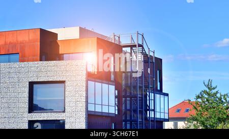 Office building facade covered in unique Corten steel, stones and glass materials. Stock Photo