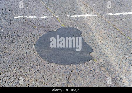 A temporary pothole repair on a road, UK Stock Photo