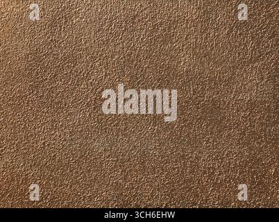 Goldish wall, texture, background. Cement wall, painted with bright orange paint. Unsmooth but flat surface in yellowed color with chaotic picture Stock Photo
