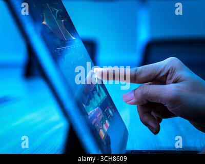 Hand touching digital tablet with data visualization graphs, representing business growth, financial investment, data analysis, AI technology, big dat Stock Photo