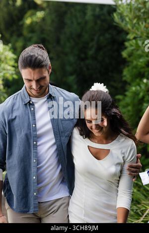 Walking together, couple celebrating wedding outdoors, smiling and sharing happiness Stock Photo