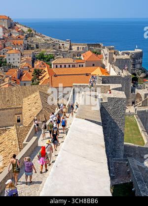 Tourists walking around the city walls in Dubrovnik Stock Photo