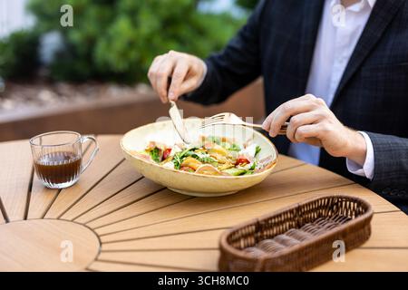 Unrecognizable professional in suit having lunch break Stock Photo