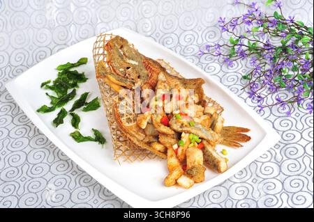 Charcoal-Grilled Turbot with Crispy Fillets in Bamboo Basket Stock Photo