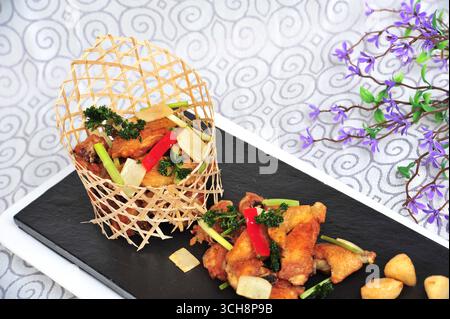 Cantonese Sand-Ginger Pan-Fried Chicken in Bamboo Basket Stock Photo