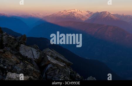 Sunrise over distant mountain with large glacier Stock Photo