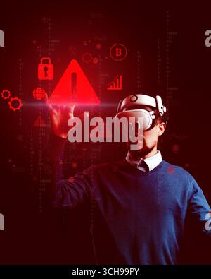 Man interacting with virtual reality display showing warning icons and data in a dark environment during a technology demonstration Stock Photo