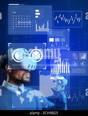 User engaging with virtual reality technology to analyze data and financial trends in a futuristic setting Stock Photo