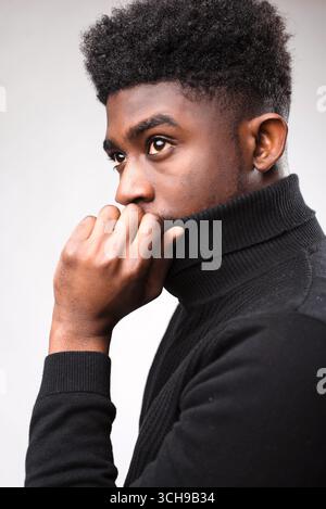 Handsome brunette man posing in black turtle neck sweater Stock Photo
