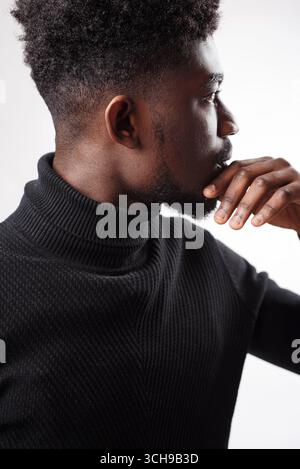 Serious authoritative bearded man standing looking away Stock Photo