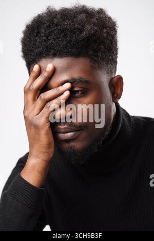 Multiracial handsome brunette man posing in black turtle neck sweater Stock Photo