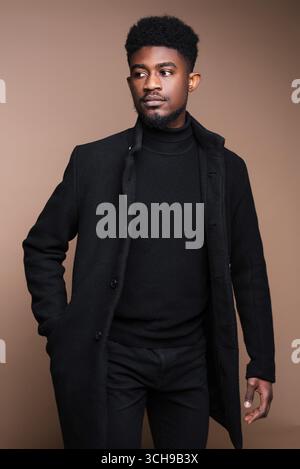 Close-up of African elegant man in black jacket posing at camera Stock Photo