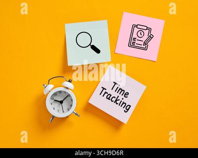 Time tracking concept with alarm clock and sticky notes showing magnifying glass and checklist on an orange background Stock Photo