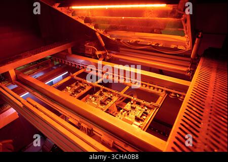 Surface mounting process of printed circuit boards during reflow soldering in a controlled environment Stock Photo