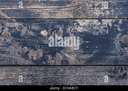 Old dark wooden planks with heavy texture, scratches, and distressed surface, rustic background perfect for vintage style design and creative backdrop Stock Photo