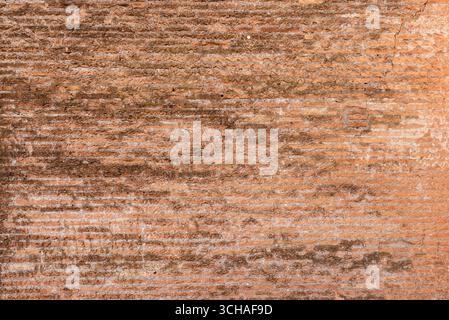 Ancient wall made of layered stones and bricks, combining earthy textures and aged architectural details Stock Photo