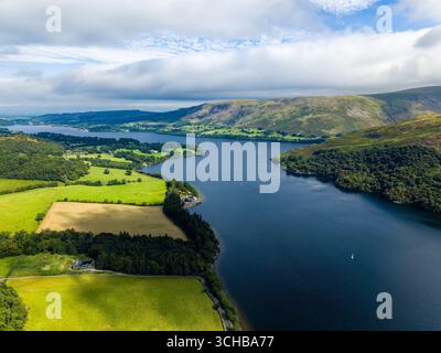 Summer day over green hills and tranquil water of Ullswater in Lake District, England Stock Photo