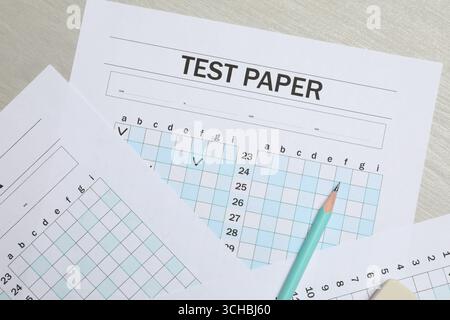 Answer sheets and pencil on wooden table, flat lay. Student passing exam Stock Photo