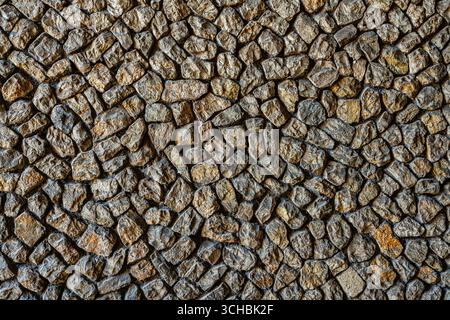 Stone wall with an abstract natural rock texture. Rustic masonry background with irregular, rough stones. Ferentino, Frosinone province, Lazio, Italy, Stock Photo