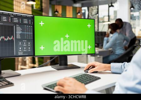 Close up of prop firm trader using mockup computer displaying candlestick graphs with stock market shares volatility. Brokerage company worker using trading platform on chroma key PC Stock Photo
