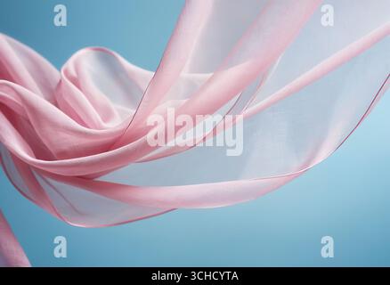 Flying pink fabric wave on blue sky background and illuminated by sunlight, flowing waving silk fluttering cloth Stock Photo