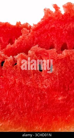 Pieces of ripe juicy red watermelon with seeds close-up on white background Stock Photo