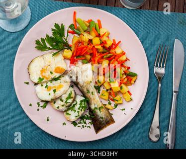 Oven baked hake with vegetable garnish Stock Photo