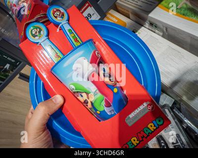 BELGRADE, SERBIA - MAY 18, 2025: plastic tableware set featuring Super Mario characters on a reusable cup and spoons in a Belgrade supermarket. Super Stock Photo