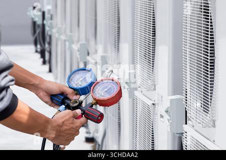 Technician checking air conditioning unit Stock Photo