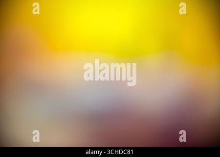 Smooth and blurry gradient background featuring a blend of yellow, orange, purple, and brown colors, creating a vibrant and modern. Backdrop for desig Stock Photo