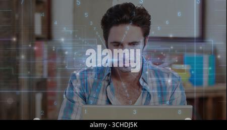 Analyzing data software developer typing code on laptop at home office desk, with digital overlays Stock Photo