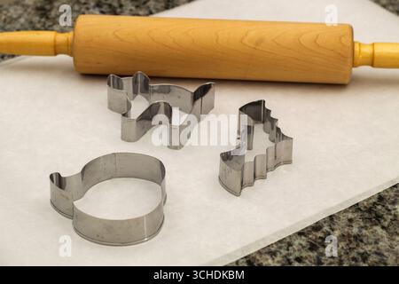 Rolling Pin and Halloween Cookie Cutters on Kitchen Counter Stock Photo