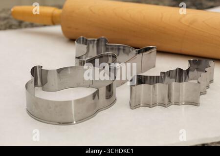 Rolling Pin and Halloween Cookie Cutters on Kitchen Counter Stock Photo