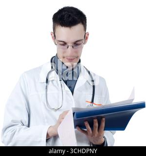 Young male doctor in glasses, standing with hands in the ECG results. Isolated on white Stock Photo