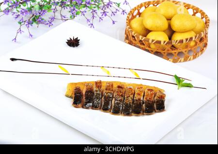 Salt-Grilled Mackerel Slices on White Platter with Minimalist Garnish Stock Photo