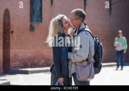 Moscow, Russia - August 29, 2025: Couple kissing in city park, man embracing woman at love date Stock Photo