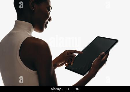 A person interacts with a digital tablet, showcasing technology usage and human interaction. Stock Photo