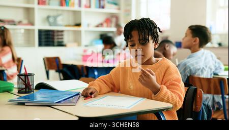 Math, count or boy in classroom for learning education, daycare or solution with students. Kindergarten, quiz or smart kid at school for child Stock Photo