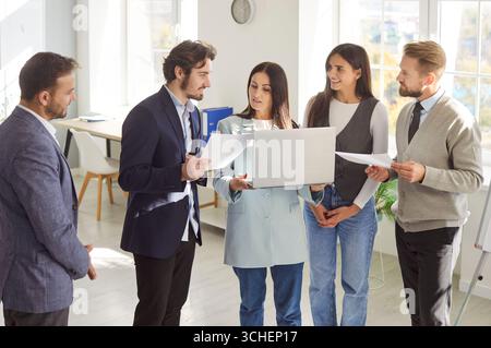Business professionals discussing project in office, collaborating, analyzing and exchanging ideas. Stock Photo