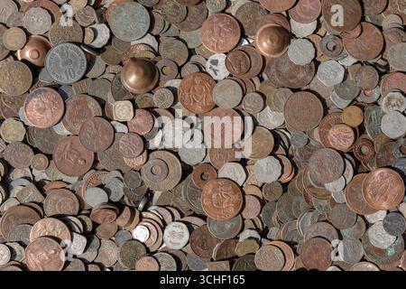 Old vintage fake coins background for sale to tourists in the Indian market on the street in Rishikesh, India. Close up, top view Stock Photo
