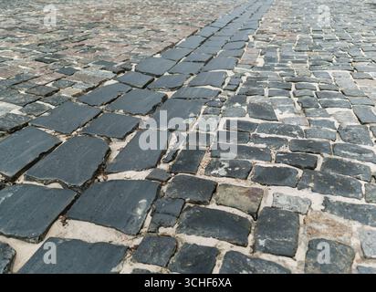 A road paved with large cobblestones, close-up. Background. Stock Photo