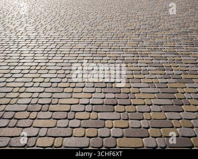 Detailed view of contemporary multicolored paving stones sparkling in the sun. Background. Stock Photo