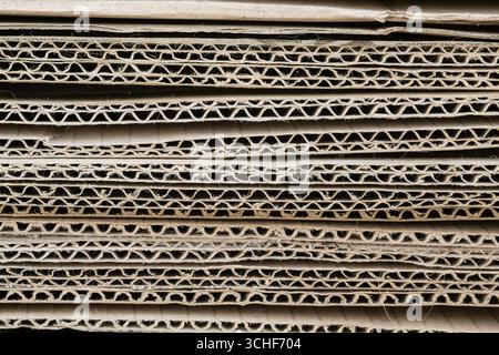 A stack of thick corrugated cardboard sheets close-up. Background. Stock Photo