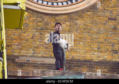 London, UK. 2nd September 2025. A protester stands next to the clock tower on top of King's Cross railway station with a dog. The man climbed on top of the station and unfurled a large 'Freedom For Iran' banner. Credit: Vuk Valcic/Ģ����ý Live News Stock Photo