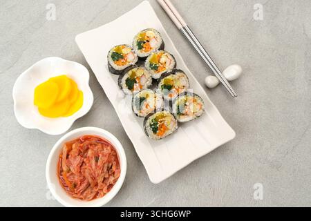Korean Rolled Gimbap, served with kimchi and danmuji. Korean food Stock Photo