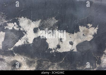 Abstract background of a weathered, cracked wall with peeling paint, creating a textured surface. Stock Photo