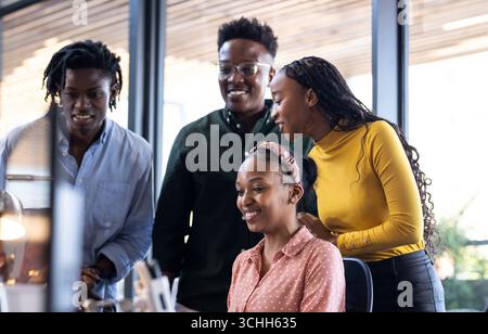 Collaborating in office, diverse team sharing ideas enthusiastically on project Stock Photo